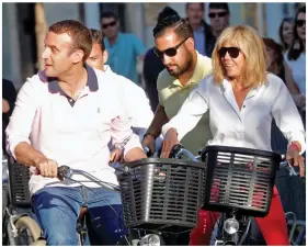  ??  ?? Questions: Macron and teacher-turned-wife Brigitte cycling. Right: A still from the footage of Benalla at the May Day protest