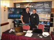  ??  ?? City Line Bar & Grill owner Robert Malkus, left and executive chef David Wagner, right, represent the Albany restaurant at a Restaurant Industry Career Fair on Monday in Albany.