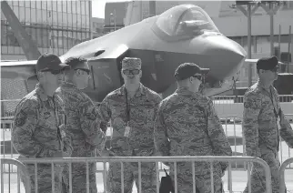 ?? MICHEL EULER/AP ?? U.S. servicemen gather next to a F-35 Lightning II at the Paris Air Show on Sunday. Canadian government officials refused to have any contact with Boeing but met other fighter jet makers in Paris.