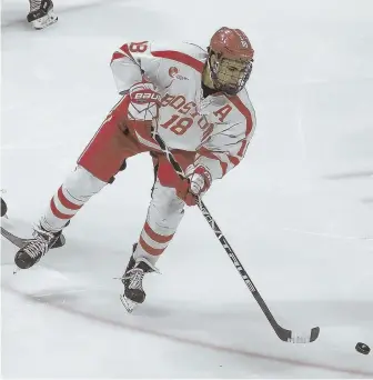  ?? STAFF PHOTOS BY NICOLAUS CZARNECKI ?? HEAD MAN THE PUCK: Boston University forward Jordan Greenway makes a pass in last night’s Hockey East playoff game vs. UConn at Agganis Arena. At left, BU forward Brady Tkachuk looks to keep the puck away from UConn’s Miles Gendron.