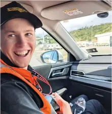  ?? Airport photo — Wellington Internatio­nal ?? Alex McGregor, a landside services support Internatio­nal Airport, holds the penguin. officer with the Wellington