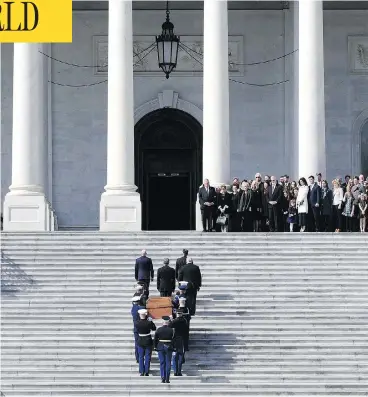  ?? SUSAN WALSH / AFP / GETTY IMAGES ?? The family of Rev. Billy Graham watches as his casket is carried up the steps of the U.S. Capitol, where Graham will lie in honour in the Rotunda. Graham received a rare tribute from U.S. political leaders Wednesday.