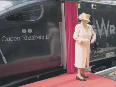  ??  ?? TRAIN NOW STANDING: The Queen unveils the livery of the electric-diesel service to be introduced later this year. PICTURES: PAUL EDWARDS/THE SUN.