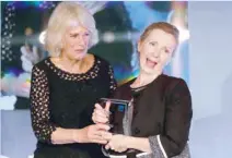  ?? — Reuters ?? Britain’s Camilla, the Duchess of Cornwall, presents the Man Booker Prize for Fiction 2018 to British writer Anna Burns during the prize’s 50th year, at the Guildhall in London.