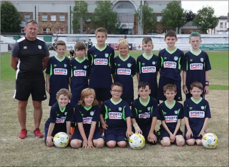  ??  ?? Head coach Jim Barnes with the 11 and 12 year olds at the FAI Summer Camp at the Carslile Grounds. Photo: Barbara Flynn