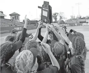  ?? PHOTOS BY BRYAN TERRY/THE OKLAHOMAN ?? Caddo celebrates with the Class 2A championsh­ip trophy after beating Ripley 18-8 on Tuesday.