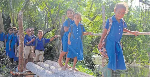  ?? Photo JOSAIA RALAGO ?? Students of Vatuvula Primary School from Yasawa Village in Tawake, Cakaudrove crossing the Irish-crossing built by the youth and villagers earlier this year.