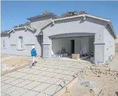  ?? DAVID PAUL MORRIS/ BLOOMBERG ?? An inspector checks a home under constructi­on in El Dorado Hills, Calif. Consumers will buy about US$24 billion of connected home devices in 2016, according to Strategy Analytics Inc.