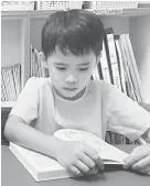  ??  ?? A pupil reads a book from a UK reading programme.