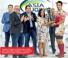  ??  ?? Captain of Japan receiving the trophy from Amali Nanayakkar­a - Group Chief Marketing Officer, Dialog Axiata PLC