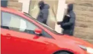  ??  ?? Armed robbers flee to a red Ford Focus after raiding a branch of Santander