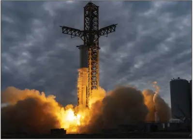  ?? (Ap/SpaceX) ?? A Starship first-stage Super Heavy booster performs an engine-firing test at the launch pad in Boca Chica, Texas, earlier this month.