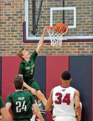  ?? PAUL DICICCO — THE NEWS-HERALD ?? Lake Catholic sophomore Luke Frazier dunks on a fast break against University on Dec 16.