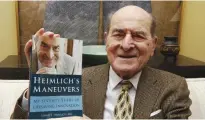  ?? — AP ?? CINCINNATI: In this Feb 5, 2014 file photo, Dr Henry Heimlich holds his memoir prior to being interviewe­d at his home.