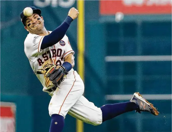  ?? Karen Warren / Houston Chronicle ?? Known for his hitting, Jose Altuve is no slouch when it comes to defense at second base as he shows during Game 2 of the ALCS at Minute Maid Park.