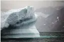  ?? BRENNAN LINSLEY, AP ?? A melting iceberg floats away from the Greenland ice sheet. Political preference­s determine how voters approach issues such as climate change, Lawrie McFarlane writes.