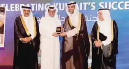  ??  ?? KUWAIT: KFH Group Chief Executive Officer Mazin Saad Al-Nahedh receives the award at a ceremony from Forbes Middle East in presence of Minister of State for Cabinet Affairs Sheikh Mohammad Abdullah Al-Mubarak Al-Sabah.