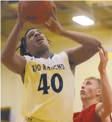  ?? ADOLPHE PIERRE-LOUIS/JOURNAL ?? Rio Rancho's Keyshawn Banks, left, grabs a rebound in front of Sandia High School's Tanner Sloan during a Jan. 9 game at Cibola High School. Rio Rancho won the game to take the Metro title.