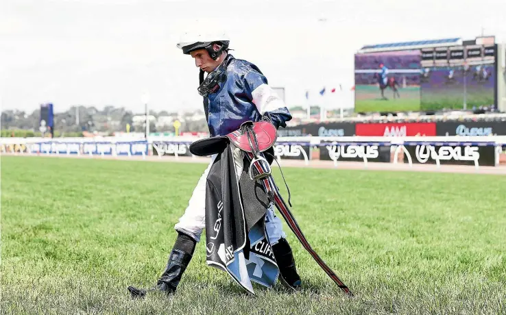  ?? GETTY ?? Jockey Ryan Moore shows the strain after his horse The Cliffsofmo­her fractured its shoulder and had to be put down during last month’s Melbourne Cup.