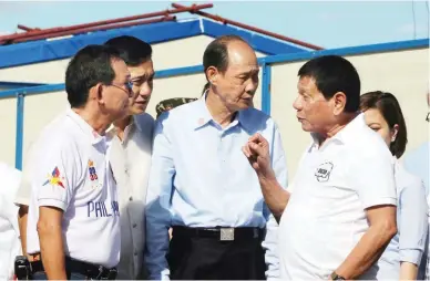  ??  ?? MEGA REHAB CENTER – President Rodrigo R. Duterte (right) talks with Huang Rulun, Chairperso­n of the Board of Century Golden Resources Group of Beijing, (center) after they inaugurate­d the Mega Drug Abuse Treatment and Rehabilita­tion Center in Nueva...