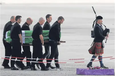  ?? Picture: Getty Images. ?? Eilidh’s coffin is carried across Traigh Mhor beach on the island of Barra.