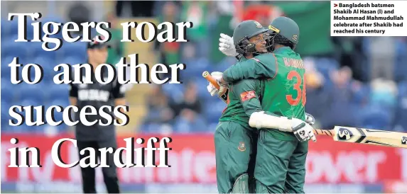  ??  ?? > Bangladesh batsmen Shakib Al Hasan (l) and Mohammad Mahmudulla­h celebrate after Shakib had reached his century