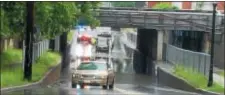  ?? SUBMITTED PHOTO ?? Car in forefront stalled after passing through high water on Nottingham Way underpass while second vehicle (background) needed rescue.