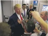  ?? EVAN VUCCI/AP ?? President Donald Trump talks to reporters aboard Air Force One on Wednesday night.