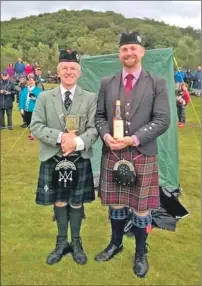  ??  ?? Photograph: Pipes|Drums Magazine. Overall piping winner Derek Midgely, right, with Ceol Mor winner Dr Peter McCalliste­r.