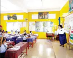  ?? HEAN RANGSEY ?? A teacher and her students at Chaktomuk Primary School in Phnom Penh’s Daun Penh district in February.