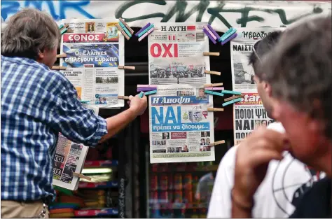  ?? AFP ?? A newsagent hangs newspapers bearing ‘No’ and ‘Yes’ headlines in central Athens, on Saturday, on the eve of the Greek referendum on its bailout terms. Nearly 10 million Greek voters will take to the ballot booths on Sunday to vote ‘Yes’ or ‘No’ in a...