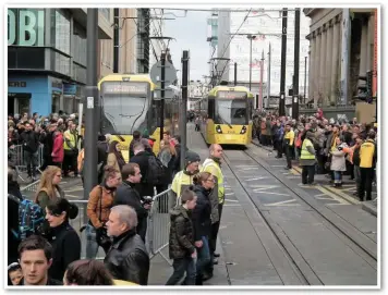  ?? MIKE HADDON. ?? Metrolink staff are on crowd control duty during Chinese New Year celebratio­ns on January 29, to allow trams safe passage along Mosley Street at its intersecti­on with Princess Street. Tram 3099 (right) approaches St Peter’s Square stop bound for...