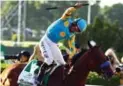  ?? AL BELLO/GETTY IMAGES ?? Jockey Victor Espinoza at the Belmont finish line aboard American Pharoah.