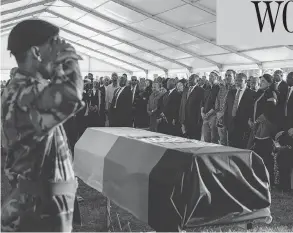  ?? GIANLUIGI GUERCIA / AFP / GETTY IMAGES ?? South African political leaders, dignitarie­s and family members stand before the casket of Ahmed Kathrada, a leading anti-apartheid activist and close colleague of Nelson Mandela, during his funeral in Johannesbu­rg on Wednesday.