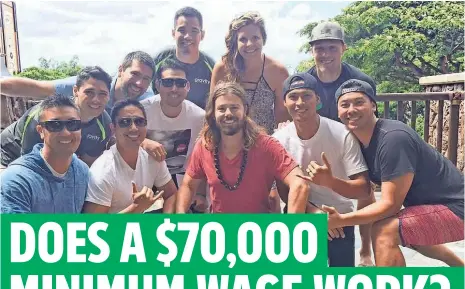  ?? GRAVITY PAYMENTS ?? Gravitymen­ts CEO PayDan Price, center, is joined by his Hawaii team. His workers say they have significan­tly less stress about the future.