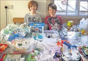  ??  ?? Participan­ts Joe and Harry Clark with plastic they collected at home