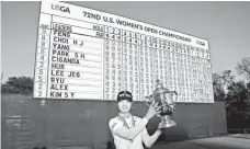  ??  ?? Sung Hyun Park poses with the U.S. Women’s Open championsh­ip trophy Sunday after her two-stroke victory.