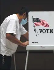  ?? JUSTIN SULLIVAN — GETTY IMAGES ?? A voter fills out his ballot at the Santa Clara County Registrar of Voters Office on Oct. 13.