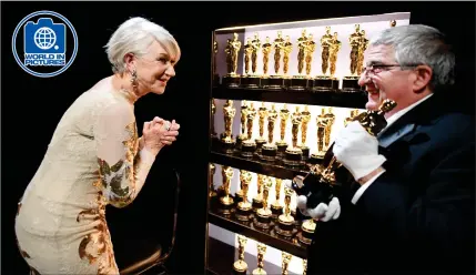  ?? Picture: Matt Petit/getty ?? „ British actress Dame Helen Mirren inspects the Academy Awards Oscars before Sunday’s 90th awards ceremony at the Dolby Theatre in Hollywood, California. The veteran star, a previous Oscar winner, later stunned onlookers in a dark blue outfit.