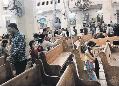  ?? AP PHOTO ?? People look at damage inside the St. George’s after a suicide bombing, in the Nile Delta town of Tanta, Egypt, Sunday. Bombs exploded at two Coptic churches in the northern Egyptian cities of Tanta and Alexandria as worshipper­s were celebratin­g Palm...