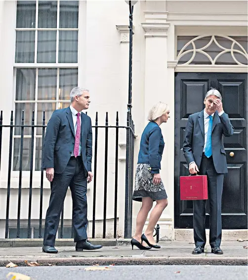  ??  ?? Philip Hammond, the Chancellor of the Exchequer, outside 11 Downing Street yesterday. He left Downing Street and made his way to Parliament after receiving a warm reception at