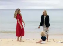  ?? GETTY IMAGES ?? Carrie Johnson, wife of the British prime minister, laughs with the First Lady of the United States, Dr Jill Biden, as Wilfred Johnson sits on the beach.