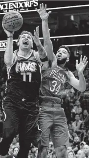  ?? Sam Hodde / Associated Press ?? Mavericks star Luka Doncic shoots inside against the Pelicans’ Kenrich Williams on Saturday night.