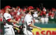  ?? ALEX BRANDON — THE ASSOCIATED PRESS ?? Washington Nationals relief pitcher Marc Rzepczynsk­i, left, and Washington Nationals left fielder Jayson Werth (28) celebrate during Game 2 of baseball’s National League Division Series against the Los Angeles Dodgers, at Nationals Park, Sunday in...