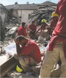  ??  ?? Rescuers pause, left, and pull a survivor out the rubble, right, in Amatrice, where a 6.1 earthquake struck just after 3:30 a.m. on Wednesday.
