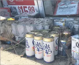  ??  ?? At Fibber’s Suds and Soda in Darby, employees waited as two dumpsters were delivered to haul the entire stock, which had been sitting in murky water, to the dump.