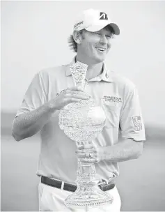  ??  ?? Brandt Snedeker reacts as he holds the trophy after winning the AT&T Pebble Beach National Pro-Am at the Pebble Beach Golf Links in Pebble Beach, California. - AFP photo