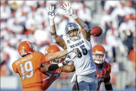  ?? AP file photo ?? Nevada defensive lineman Tristan Nichols tries to block a pass attempt by Boise State quarterbac­k Hank Bachmeier during a game on Oct. 2. Nichols led the Mountain West with 10 sacks this season.