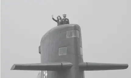  ??  ?? RISING TENSIONS Taiwan President Tsai Ing-wen waves from a Duch-made Sea Tiger submarine at the Tsoying navy base in Kaohsiung, southern Taiwan on Wednesday. Taiwan formally launched an ambitious project to build its own submarines as the island faces...