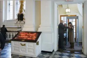  ?? MARK LENNIHAN — THE ASSOCIATED PRESS ?? In this photo, a security guard checks a visitor at the entrance to St. Paul’s Chapel in New York. Two New York City churches that survived the destructio­n of World Trade Center have become the latest city tourist sites to embrace post-9⁄11 security...